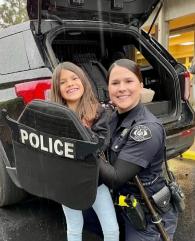 Smiling police officer with a child.